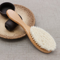 Wooden brush with natural bristles on a textured surface