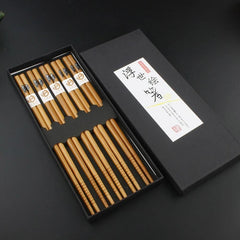 Set of wooden chopsticks in a black box