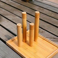 Set of bamboo utensil holders on a wooden tray