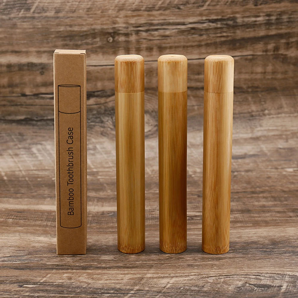 Set of bamboo toothbrushes and packaging on a wooden background