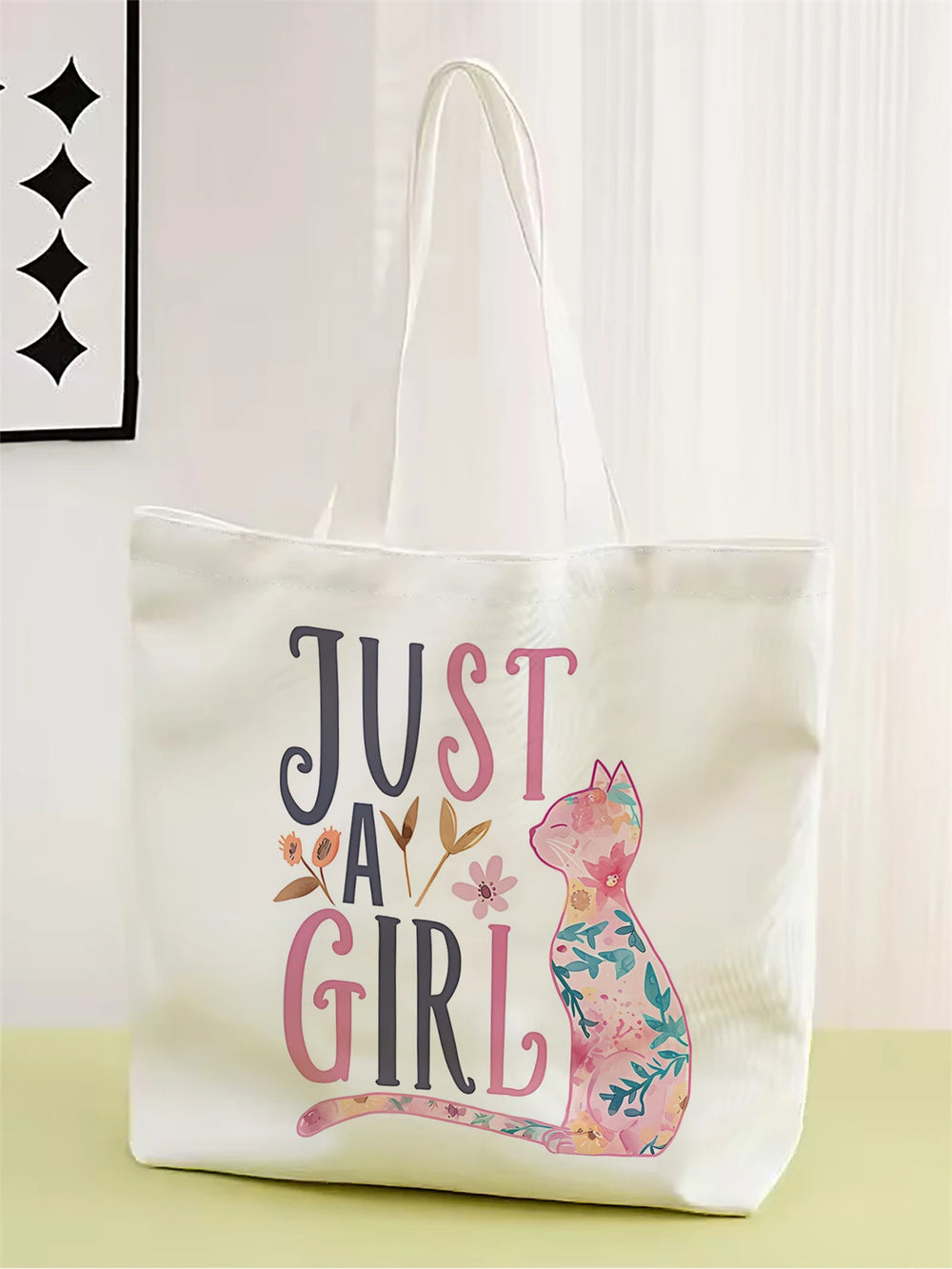 Tote bag with 'Just a Girl' text and floral cat design on a white background