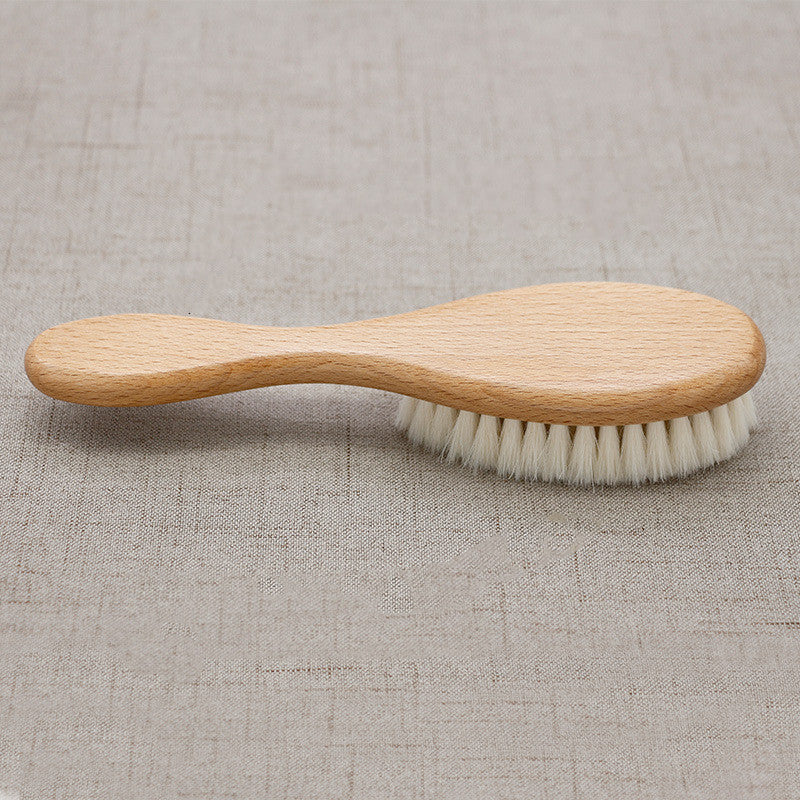 Wooden brush with bristles on a textured beige background