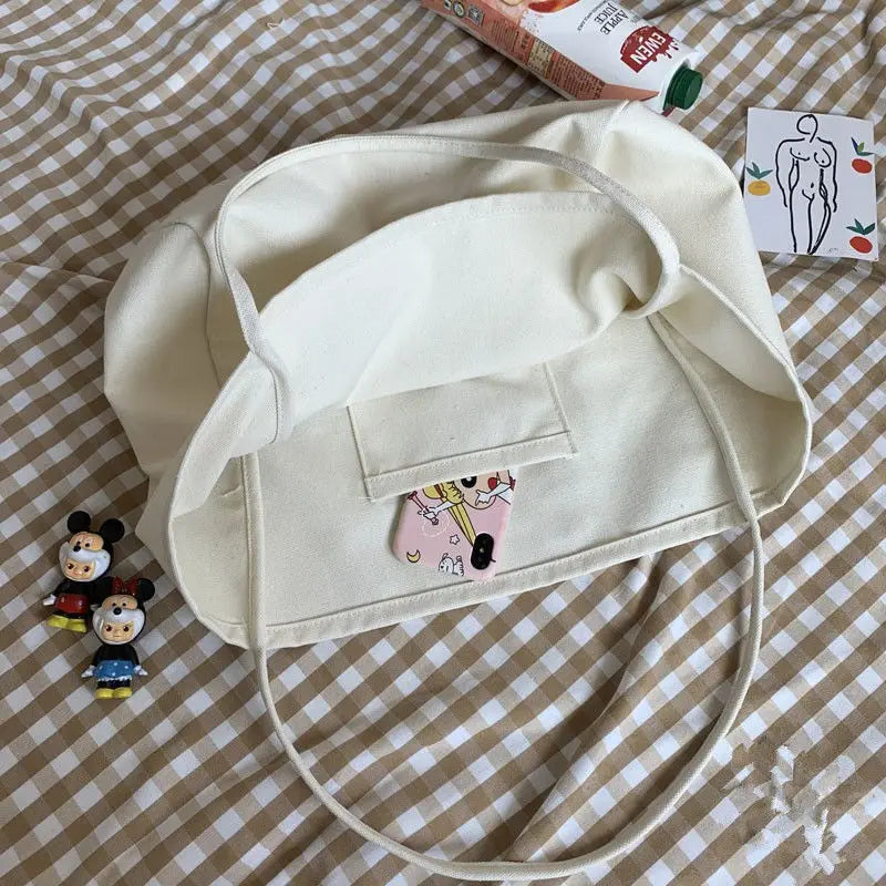 Beige bucket hat with cartoon character patch on a checkered fabric background