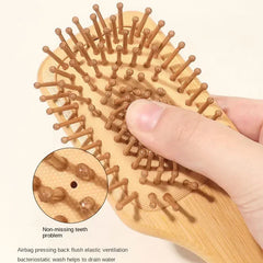 Wooden hairbrush with a close-up of non-missing teeth and airbag pressing feature.