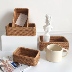 Set of woven Handwoven Rattan Storage Basket on a white surface with a mug and decorative item.